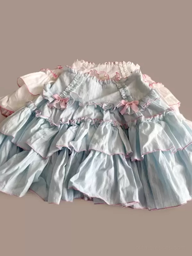 Light blue Sweet Lolita tiered skirt with pink trims tiny pink bows and multi-layered ruffles static flat lay view