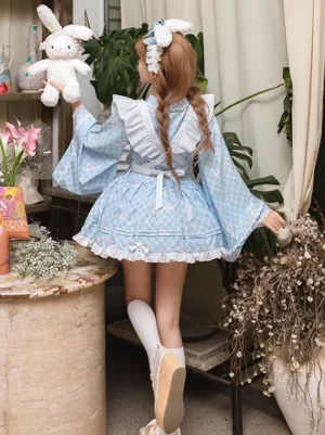Back full view of light blue gingham lolita maid dress displaying ruffled skirt hemline braided hair with flower hairpin and layered ruffle details from rear angle