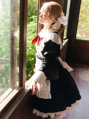 Maid-style lolita dress with black-white-red color scheme worn by blonde model, left side view against vintage wooden window with lace trims and red neck bow