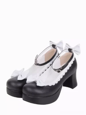 Black and white Sweet Lolita chunky heel pumps with scalloped white lace trim and decorative bows, front three-quarter view on white background, showcasing round toe and ankle buckle strap