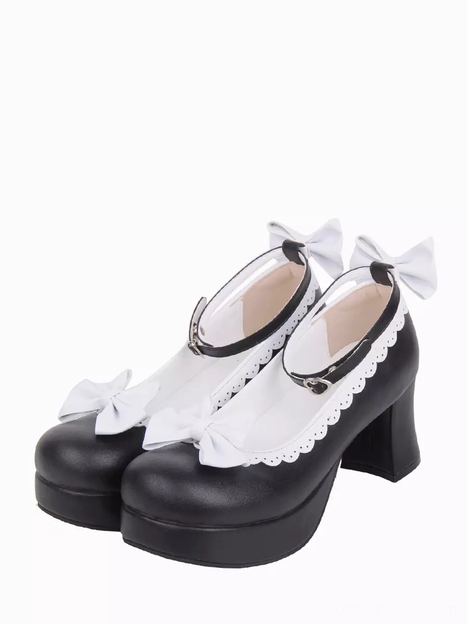 Black and white Sweet Lolita chunky heel pumps with scalloped white lace trim and decorative bows, front three-quarter view on white background, showcasing round toe and ankle buckle strap