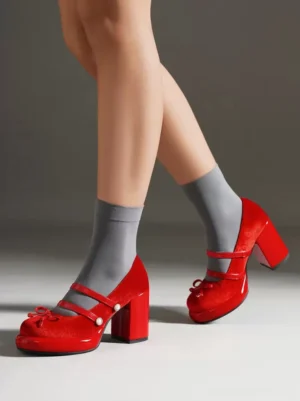 Sweet Lolita Mary Jane pumps red nubuck side view with bow detail and chunky heel worn with grey crew socks