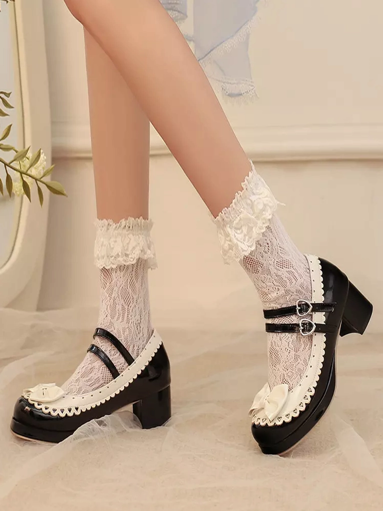 Side partial view of black and white sweet lolita mary jane shoes on model wearing ruffled lace stockings with indoor wall greenery backdrop setting