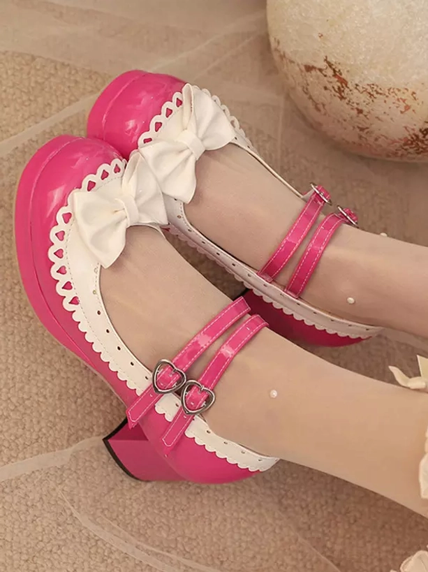 Hot pink color block sweet lolita platform shoes overhead flat lay display with decorative ornaments, featuring double buckle straps and white scalloped bow trim details