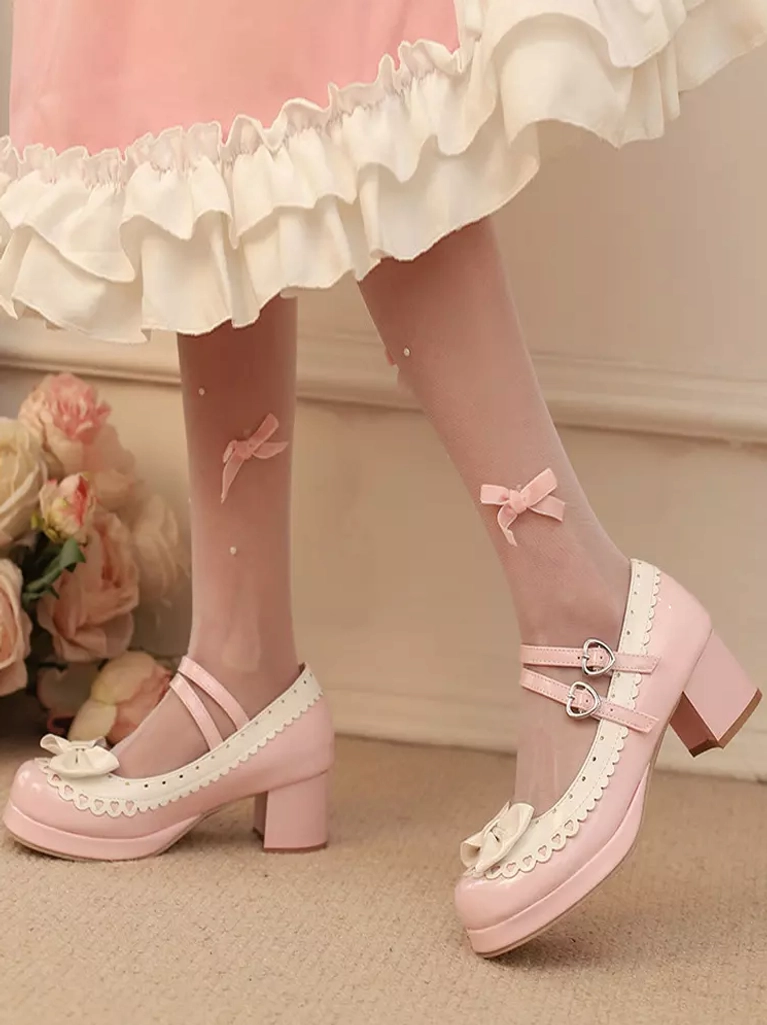 Side view of sweet lolita mary jane shoes in light pink on model wearing ruffled pink dress and bow-accented stockings, indoor floral backdrop setting