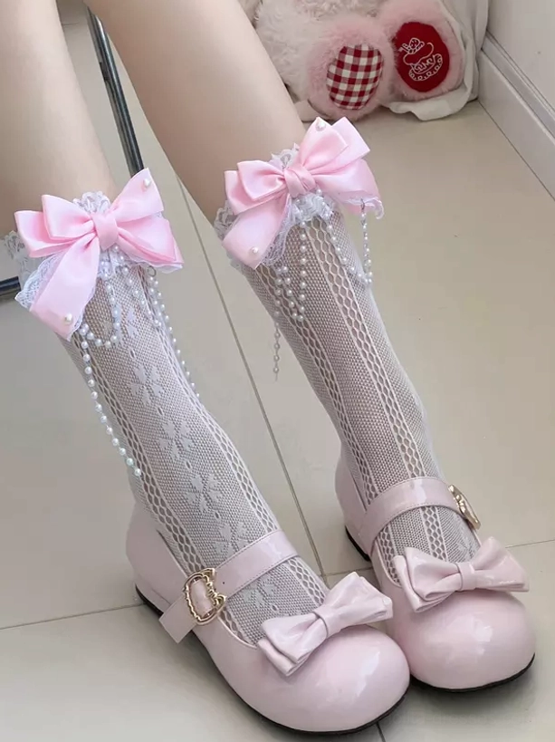 Sweet lolita mid-calf socks with hollow lace design pink bow and pearl tassel decoration side oblique view on model