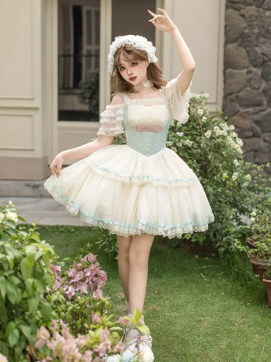 Sweet lolita mini pinafore dress dynamic side shot model twirling fluffy tiered tulle skirt light blue ribbon accents