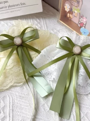 Multiple sweet lolita oversleeves color variations including cream yellow and white ruffled lace with matching matcha green bow decorations displayed together