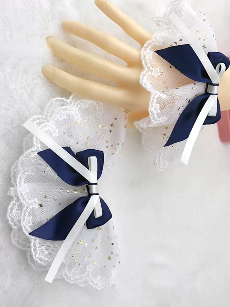 Navy blue satin bow with white star-printed ruffled mesh wrist cuffs and lace scalloped edge, Sweet Lolita arm accessories displayed on hands