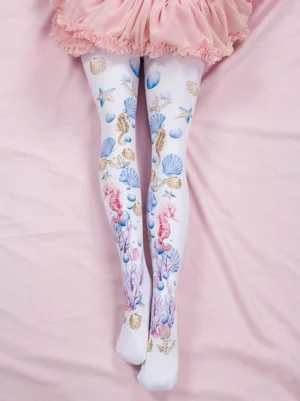Sweet Lolita white ocean-print tights with pink spandex animal print worn with pink ruffled skirt overhead view on pink bedding