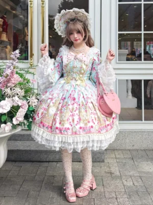 Blue floral sweet lolita one-piece dress with lace-up bodice front view on model wearing bonnet at outdoor flower garden
