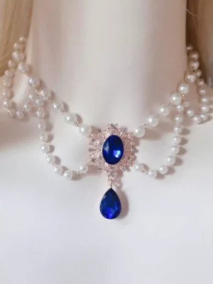 Sweet Lolita pearl choker accessory with royal blue gemstone pendant, rose gold filigree frame, double-layer pearls, and teardrop rhinestones on mannequin display