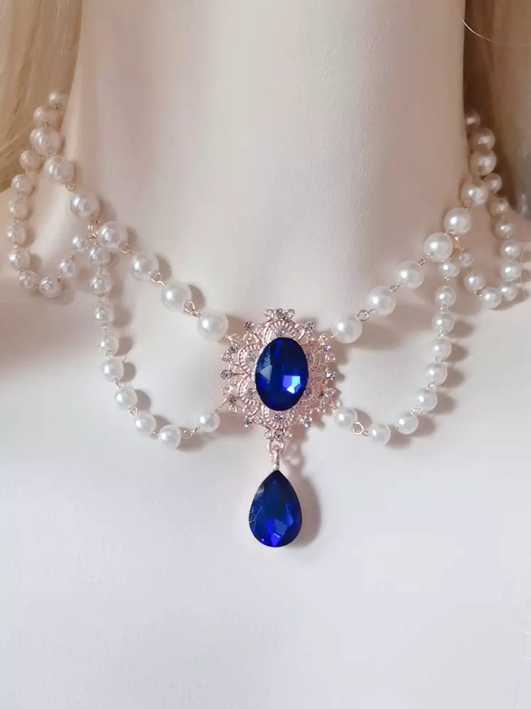 Sweet Lolita pearl choker accessory with royal blue gemstone pendant, rose gold filigree frame, double-layer pearls, and teardrop rhinestones on mannequin display