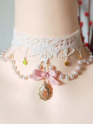 Sweet lolita pearl lace choker with pink satin bow and teardrop gem pendant on mannequin neck, featuring white floral lace and mixed-color heart trinkets, front view with red flower branches backdrop