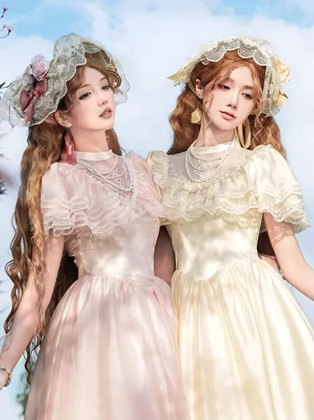 vintage lolita fashion pearl necklace styling cream pink gown three-quarter view sunny outdoor portrait