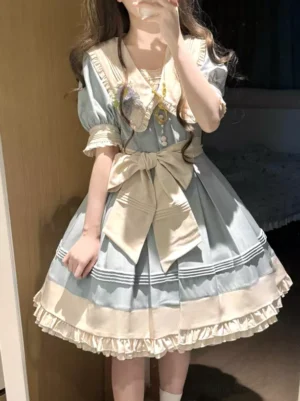 Light sky blue Sweet lolita dress front mirror selfie angle featuring large waist bow, Peter Pan collar with brooch decoration, short puff sleeves with cuffs, and multi-tiered ruffled skirt hem