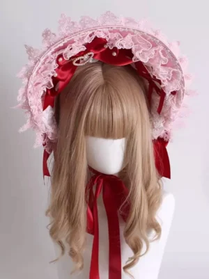 Sweet lolita pink bonnet headpiece front view with embroidered lace frills red satin bows heart brooch on blonde mannequin