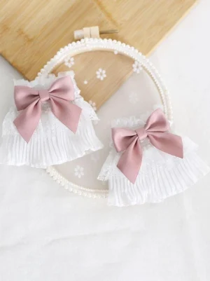 Sweet Lolita ruffled oversleeves with pink satin bow, white pleated lace cuff, frilled edges, styled on wooden board with embroidery hoop flat lay photography