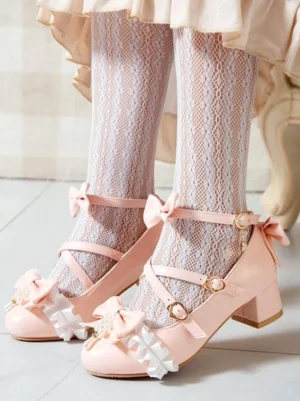 Pink sweet lolita chunky heel pumps with decorative bow and ruffle trim embellishments shown in overhead front view, displayed with model wearing fishnet lace socks and ruffled lolita skirt, featuring ankle buckle strap closure and delicate feminine design elements