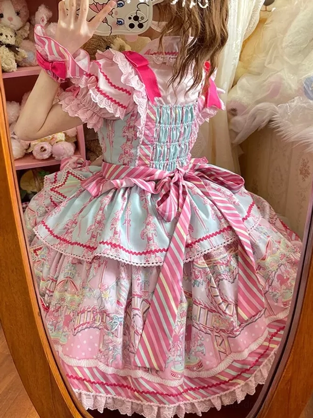 Back mirror selfie of girl wearing pink sweet lolita dress showing shirred back design, striped waist sash detail in plush toy background