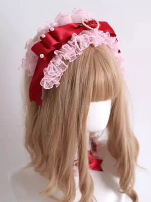 Sweet lolita pink lace bow headdress with wine red satin bow pearl and heart-shaped rhinestone embellishments on mannequin with curly wig rococo style headwear