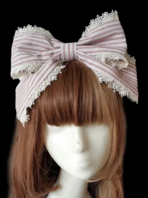 Sweet lolita striped bow hair clasp in pink and white with white lace trim details, front view on mannequin with brown hair, classic lolita hair accessory