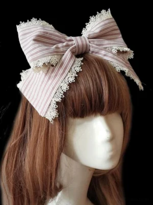 Sweet lolita hair clasp side profile view showing pink and white striped bow design with delicate lace trimmings, lolita headwear accessory styling
