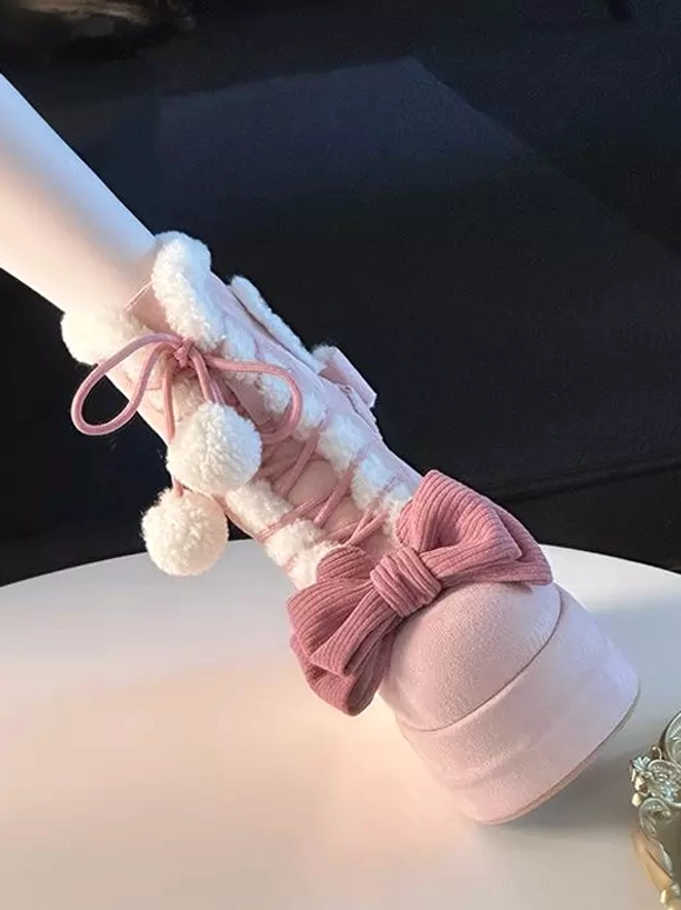Pink sweet lolita ankle boots side oblique view on model leg large pink bow thick platform sole fluffy pom pom decorations