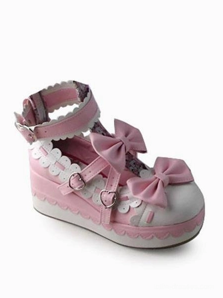 Single Lolita platform shoe three-quarter right side view highlighting thick platform sole dual bow decorations and visible heart-shaped buckles with scalloped detailing