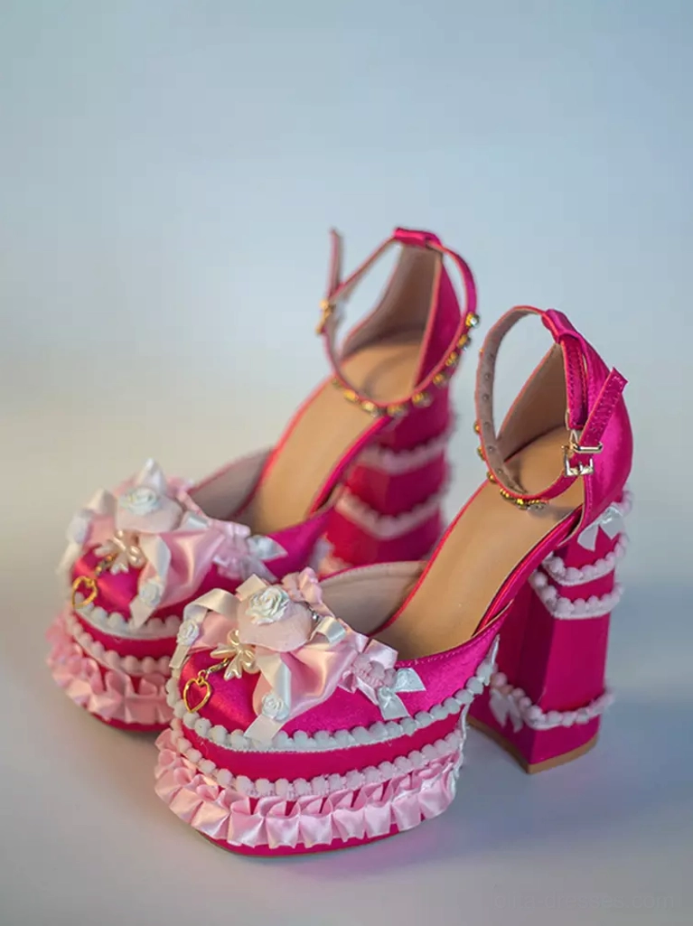 Hot pink Sweet Lolita platform pumps side front view for shoe pair displaying hot pink fabric, ruffled platform sole, floral front decoration, ankle strap detail