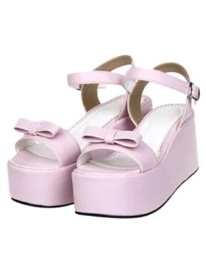 Pastel pink sweet lolita platform sandals featuring high platform wedge, ankle strap buckle closure, and decorative front bow - top front pair showcase