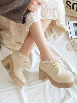 Beige Sweet Lolita chunky heel platform shoes with ruffled lace collar worn with lace-up closure and round toe, styled with gray knitwear and lace skirt in indoor home setting