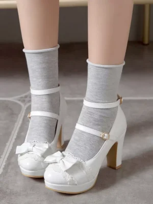 Sweet Lolita white platform shoes with bow and lace embellishments worn with grey socks indoor casual coordinate front low angle view