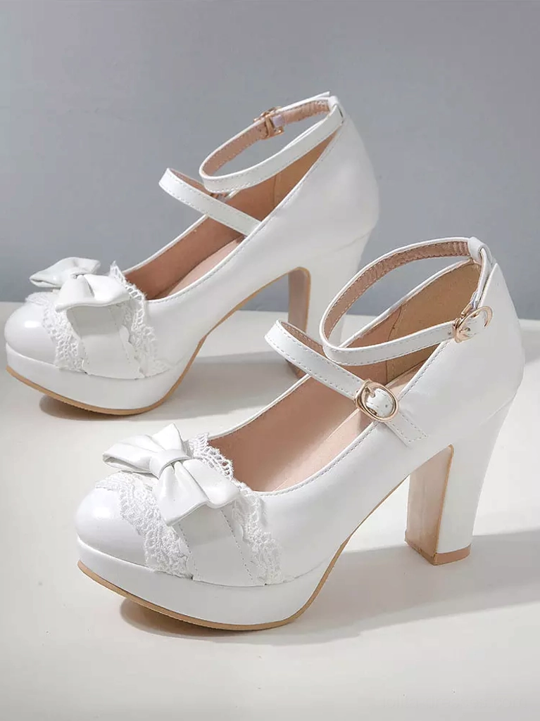 White sweet Lolita chunky platform shoes front oblique angle static product shot displaying bow embellishment and ankle strap detail