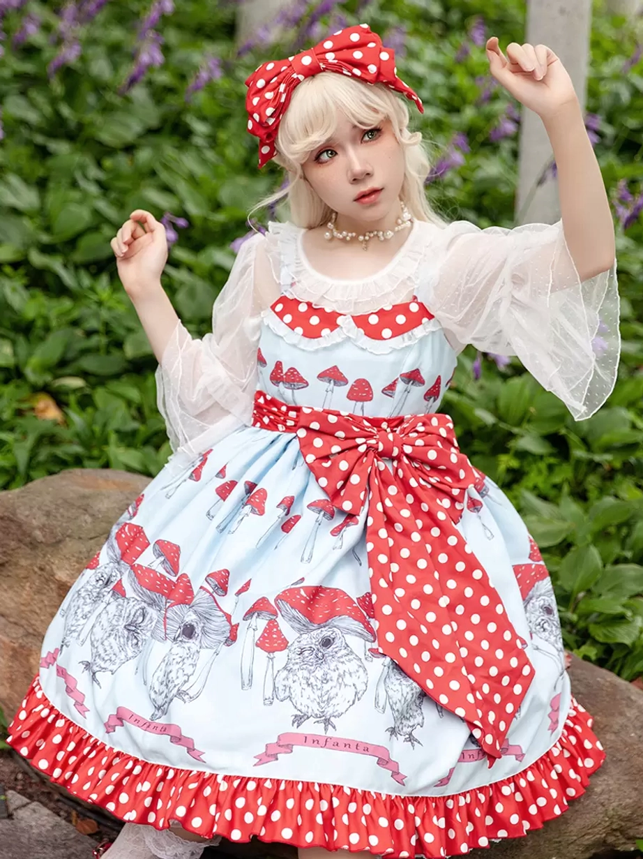 Sweet lolita coordinate outfit with light blue dress mushroom print and matching red polka dot headband in outdoor garden setting