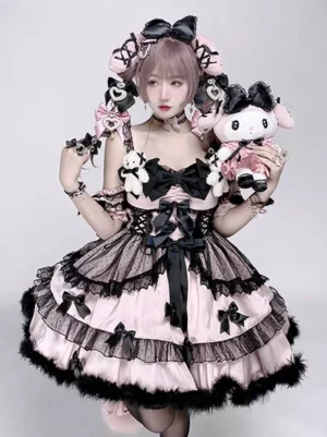 Pink and black sweet lolita princess dress front three-quarter view with tiered ruffled skirt, black fuzzy hem, large front bow, and pink-haired model holding plush toy