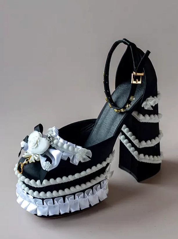 Black Sweet Lolita chunky heel pumps front three-quarter view with black upper, white ruffled trims, bow and flower decoration, block heel construction
