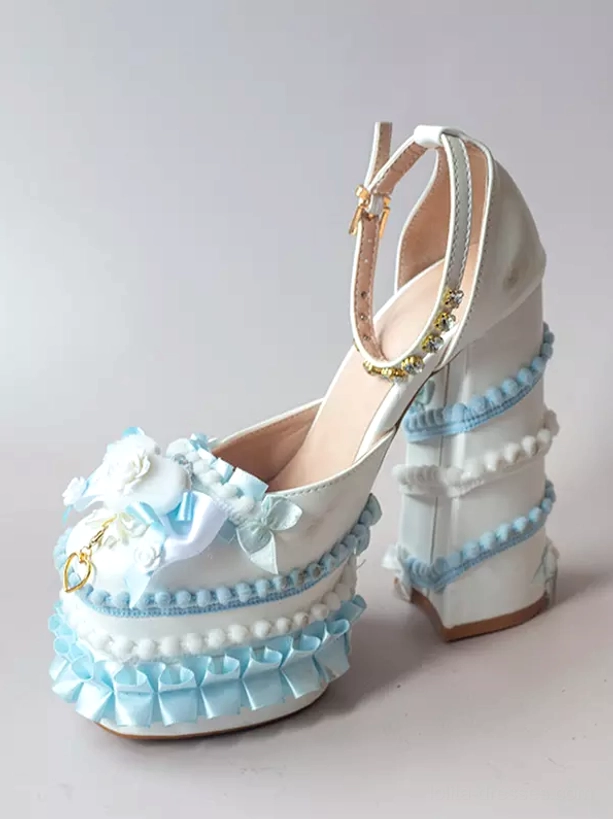 Blue-white themed Sweet Lolita chunky heel pumps front three-quarter view with white upper, blue ruffled trims, bow and flower decor, rhinestone ankle strap accent