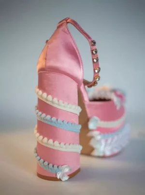 Sweet Lolita platform pumps rear side angle showing pink upper, striped ruffled block heel construction, and rhinestone ankle strap embellishment detail