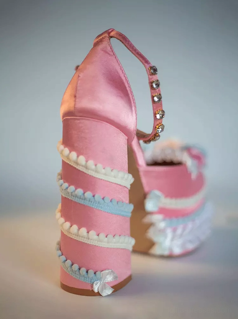 Sweet Lolita platform pumps rear side angle showing pink upper, striped ruffled block heel construction, and rhinestone ankle strap embellishment detail