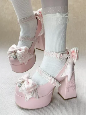Side view of pink Sweet Lolita platform pumps with decorative bow and rhinestone detail, worn with white ruffled ankle socks, showcasing chunky block heel and glossy PU leather finish