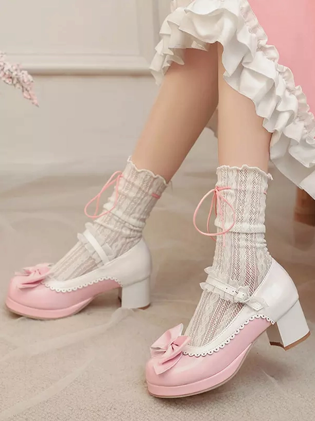 Oblique angle view of sweet Lolita pink and white Mary Jane pumps displaying toe bow decoration, block chunky heel, and patent leather construction with lace socks