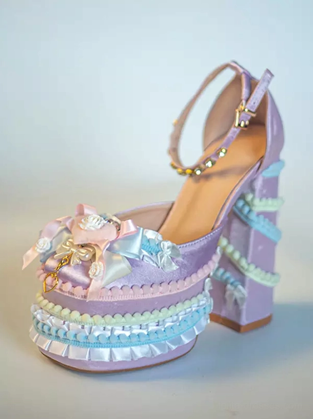 Pastel purple Sweet Lolita chunky heel pumps front three-quarter view with purple upper, multi-color ruffled trims, bow and flower decoration, rhinestone ankle strap