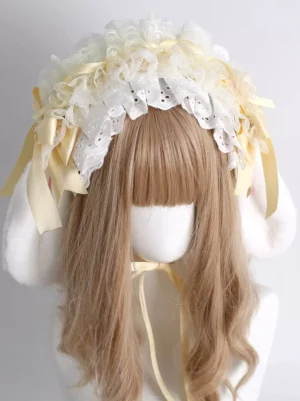 Sweet lolita rabbit ear headband with cream eyelet lace ruffles and yellow satin bows worn by mannequin with light brown bangs, front direct view showcasing white plush bunny ears and delicate lace detailing