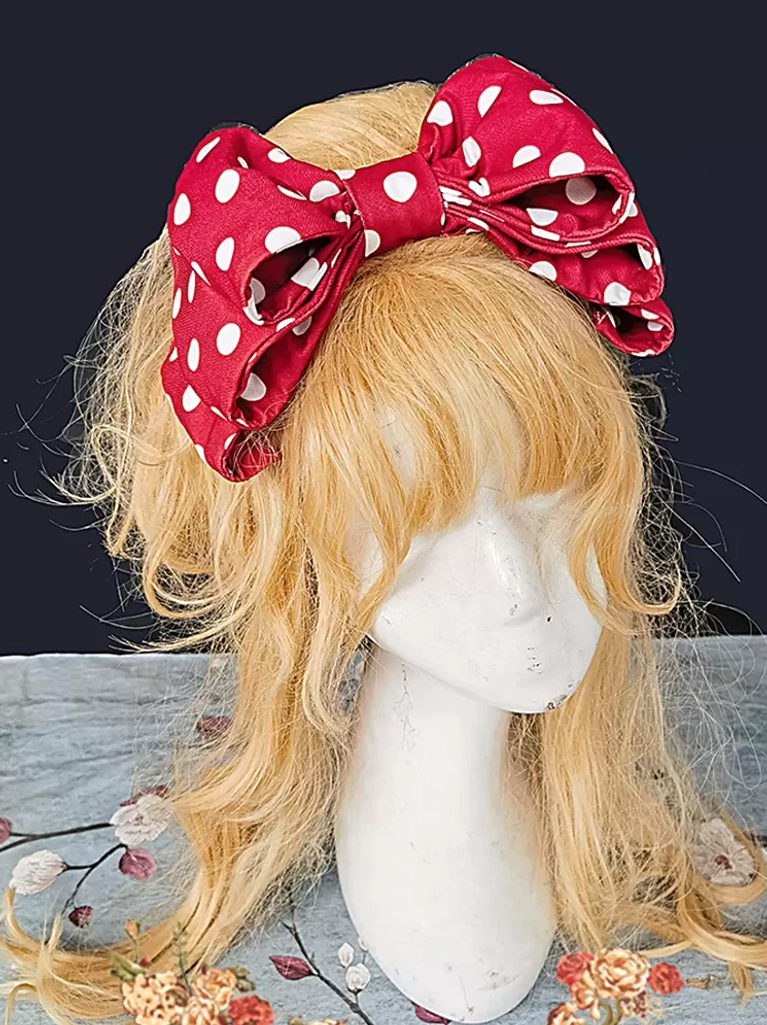 Sweet lolita red polka dot bow hair accessory three-quarter side view on mannequin with blonde curly wig