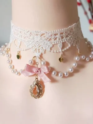 Sweet lolita rococo choker with white floral lace, pink bow, teardrop rhinestone pendant and all-gold heart charms on mannequin, front close-up detail shot with red flower background