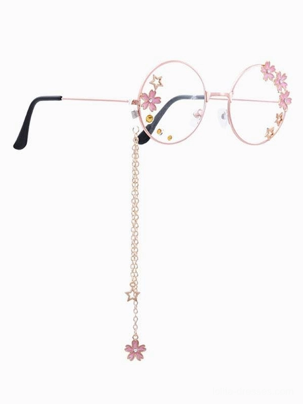 Single pair sweet lolita decorative round frame glasses rose gold metal frame with pink sakura flower decor, star and yellow dot lens accents, metal chain with coordinating flower and star pendant, right side flat lay