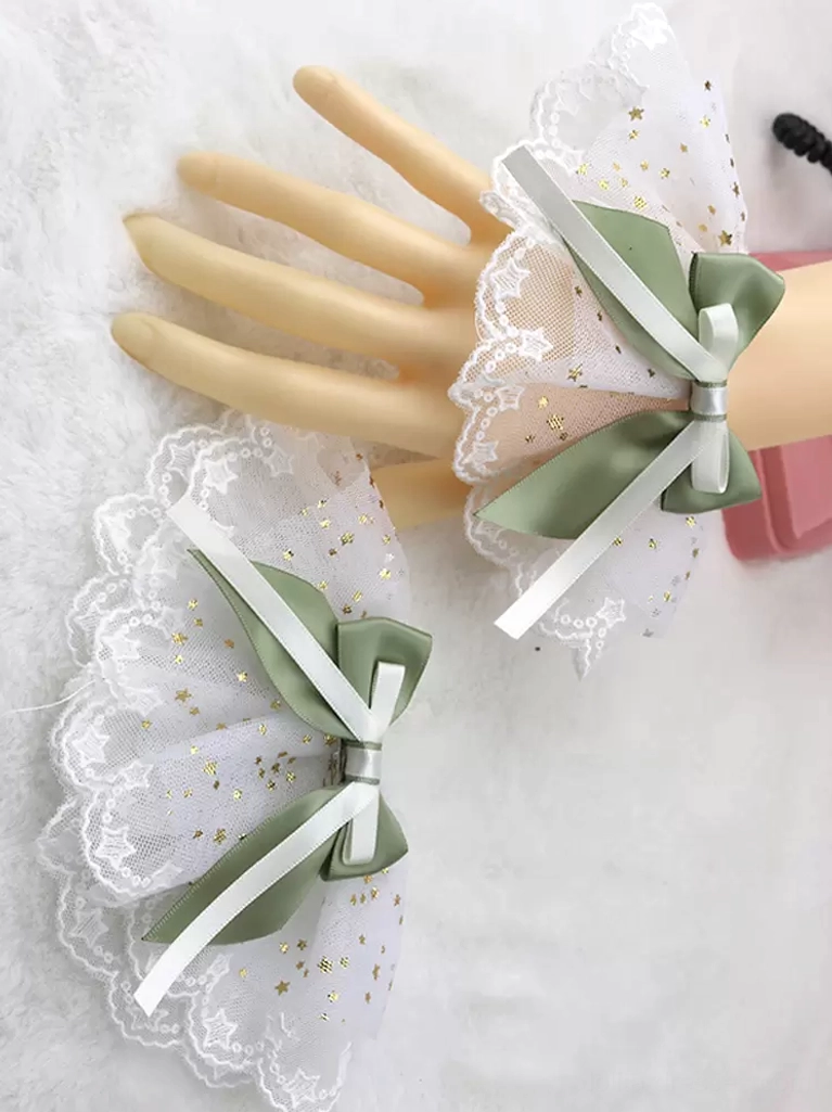 Sage green satin bow with white star-printed ruffled mesh wrist cuffs, delicate lace trim, Sweet Lolita accessory set on mannequin hands