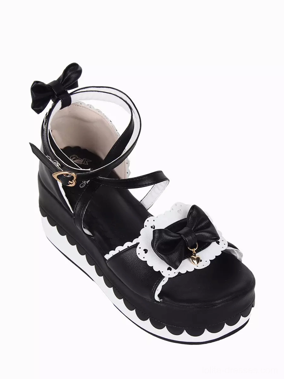 Sweet Lolita platform sandal front three-quarter view featuring closed toe section, lace-trimmed bow accent, wedge platform sole with scalloped edge design
