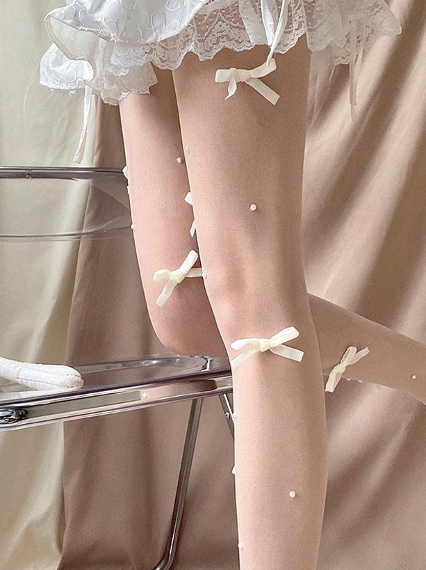 Sweet lolita sheer tights close-up side leg view off-white satin bows tiny faux pearls sheer nude fabric detail shot